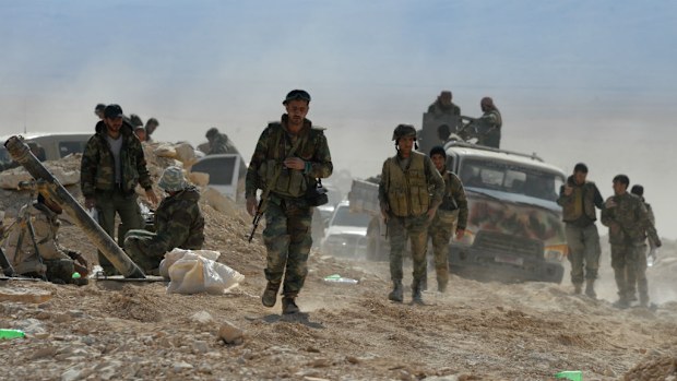 Syrian government army soldiers and militia are on the fringes of terrorist-held town of Al-Karyatein. (AAP)
