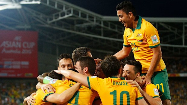 Matt McKay of Australia celebrates with team mates after scoring a goal against Oman. (Getty)