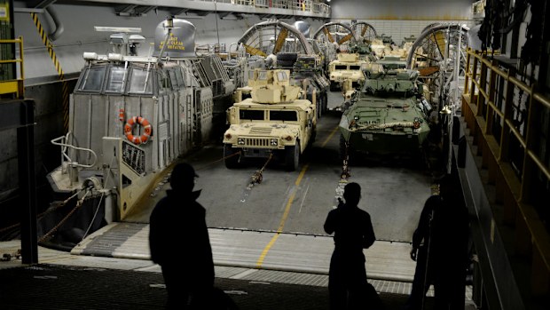 Military vehicles sit below deck on board US amphibious assault ship the USS Bonhomme Richard in Sydney during training operations last year. (AAP)