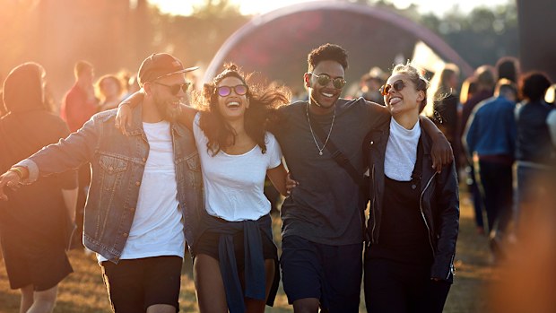 Friends hanging out at big music festival