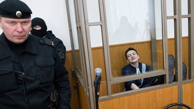 Ukrainian pilot Nadezhda Savchenko smiles in a glass cage inside court. (AP)