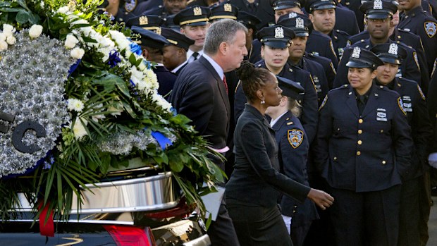 New York City Mayor Bill de Blasio and his wife, Chirlane McCray, arrive for the funeral of New York City police officer Rafael Ramos. (AAP)