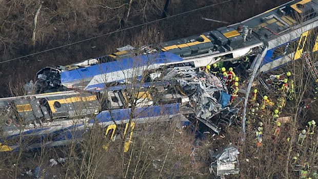 Rescue workers stift through the wreckage for any signs of survivors. (AAP)