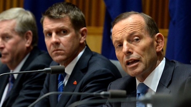 Prime Minister Tony Abbott (right) next to NSW Premier Mike Baird at COAG. (AAP)