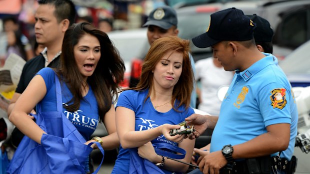 Women pass out condoms on the streets of Manila to promote safe sex on Valentines Day. (AFP)