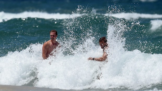 Beach goers cool off at Surfer's Paradise. (AAP)