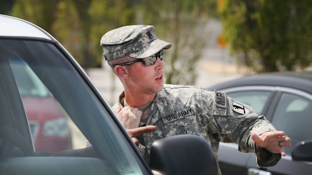 A Military Police officer with the Missouri Army National Guard directs traffic in Ferguson. (AP)