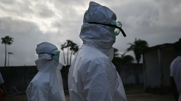 A burial team from the Liberian Ministry of Health prepares to unload the bodies of Ebola victims at a crematorium. (Getty Images)