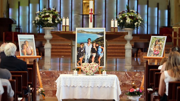 Photographs of the Harley Cuzens and his daughters appear during a memorial service for two of his deceased children, Jane and Jessica, at St Mary's Cathedral in Perth on December 29, 2011. (AAP)