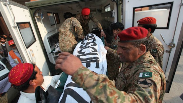 Pakistani soldiers shift bodies of the victims who were killed when Taliban gunmen attacked an Army run school, in Peshawar, Pakistan. (Getty Images)