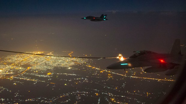 Two Royal Australian Air Force (RAAF) F/A-18F Super Hornets conduct air to air refuelling in Iraq. (AAP/Australian Department of Defence, Sergeant Hamish Paterson)