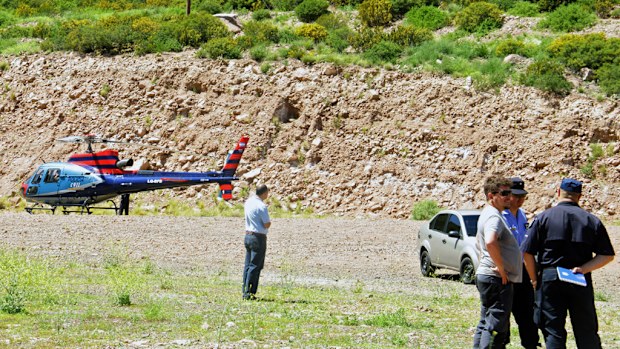 Authorities near the scene of the helicopter crash in Argentina. (AFP)