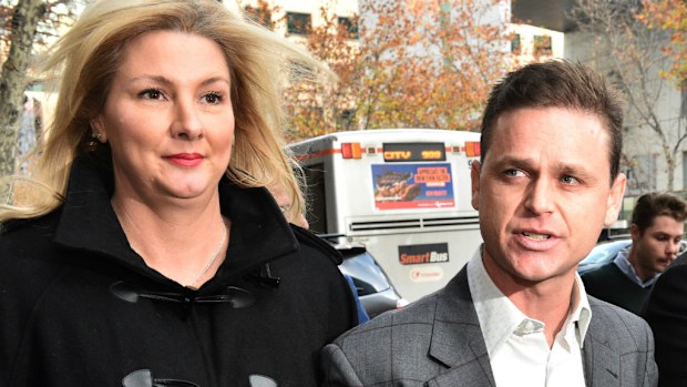 Jockey Danny Nikolic (right) and his partner Tania Hyett leaving the Supreme Court today. (AAP)