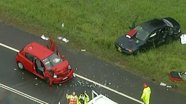 A couple and a child have been rushed to hospital after the crash at Bringelly. (9NEWS)