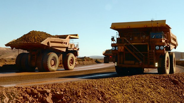Two trucks pass each other at a mine in the Pilbara in Western Australia. (AAP)
