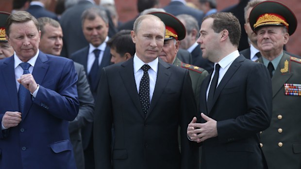 Russian President Vladimir Putin, Prime Minister Dmitry Medvedev and Chief of the Staff Sergei Ivanov attend a wreath laying ceremony at the Tomb of Unknown Soldier. (Getty Images)