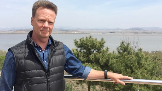 9NEWS reporter Brett McLeod with North Korea in the background. (Supplied)