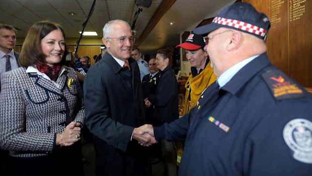 Malcolm Turnbull greets volunteer firefighters with the federal member for Corangamite, Sarah Henderson, as he attends a Volunteers Fire Brigade Victoria breakfast event in the federal seat of Corangamite in Geelong. (AAP)