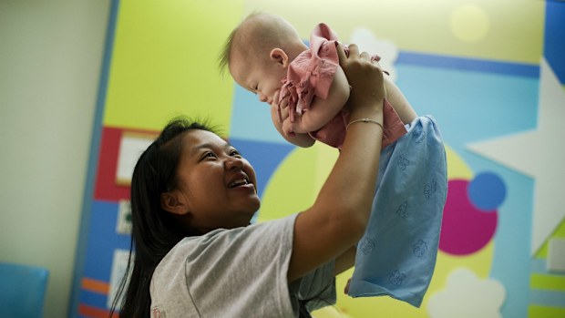Thai surrogate mother Pattaramon Chanbua plays with her baby Gammy, born with Down Syndrome. (NICOLAS ASFOURI/AFP/Getty Images)