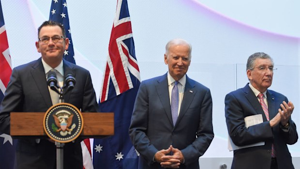 US Vice President Joe Biden (centre) speaks to guests with Victorian Premier Daniel Andrews (left) and Professor Jim Bishop (right) after a tour of the Victorian Comprehensive Cancer Centre in Melbourne. (AAP)