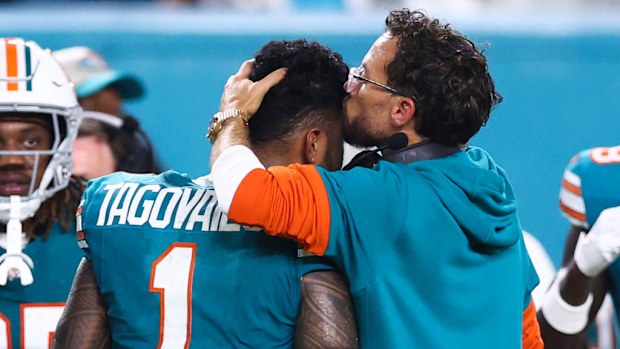 Head coach Mike McDaniel of the Miami Dolphins embraces Tua Tagovailoa #1 after leaving the game with an injury.