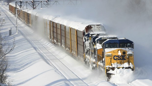 A freight train ploughs its way through heavy snow in upstate New York. (AAP)