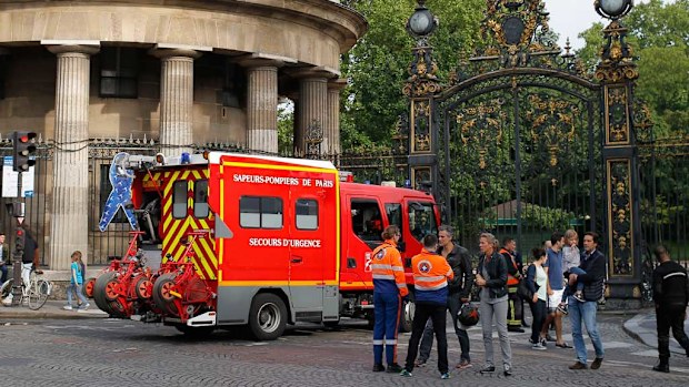 
A fire truck is parked at the entrance to Monceau parc in the centre of Paris, after a lightning bolt crashed down onto a park, striking 11 people at a child's birthday party. (AP)