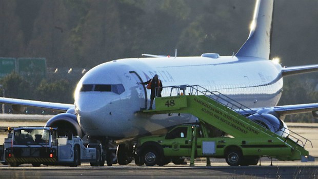 Officers search the grounded planes. (AAP)