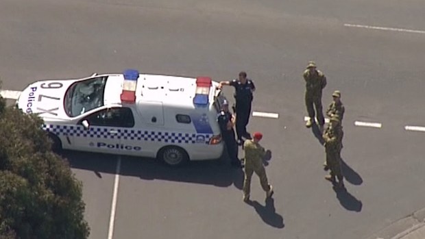 Police speak with military personnel outside HMAS Cerberus during last month's security scare. (9NEWS)