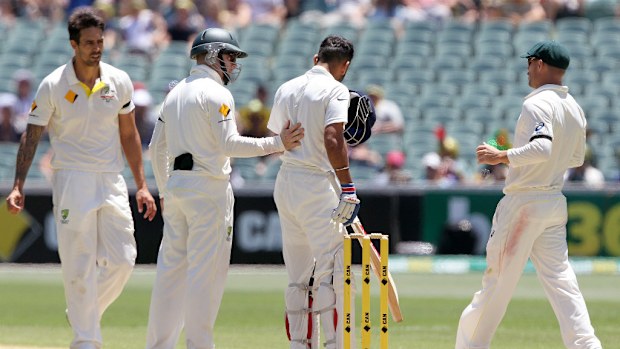 Mitchell Johnson and his Australian teammates rush to Virat Kohli's side after the Indian skipper was hit by a bouncer. (AAP)