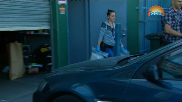 Police remove materials from the property. (9NEWS)