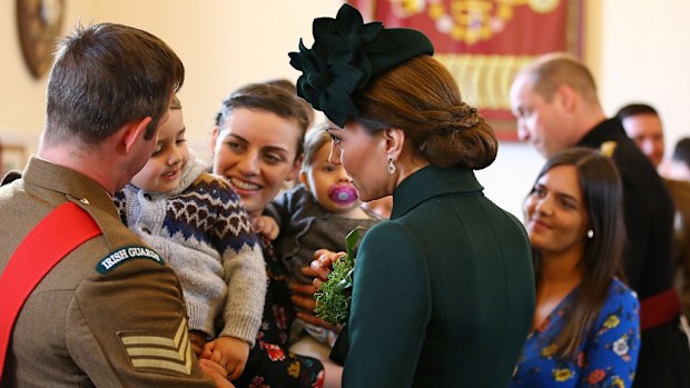 The admittedly 'broody' Duchess greeted a toddler at the celebration.