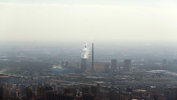 White smoke billows from a coal-fired power plant near the residential buildings in Beijing, Saturday, Sept. 3, 2016. China announced on Saturday that it has ratified the emissions-cutting agreement reached last year in Paris, giving a big boost to efforts to bring the accord into effect by the end of this year. (AAP)