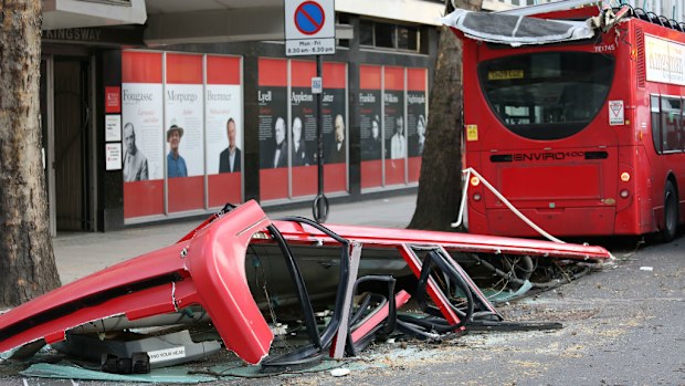 Part of the roof of a bus lies on the road in Kingsway, London. (AAP)