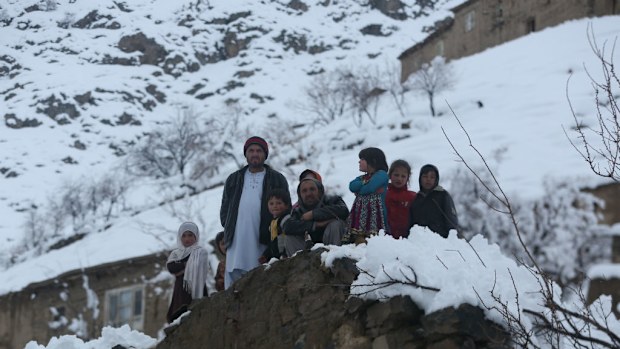 Afghan villagers look on in a village close to an avalanche site in Panjshir province north of Kabul. (AAP)