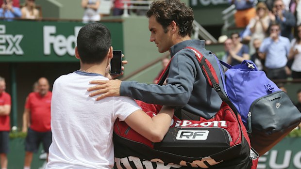 A young fan gets a selfie with Roger Federer at the French Open. (AAP)