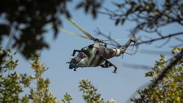 A Ukrainian attack helicopter flies near a military camp in Kramatorsk. (European Pressphoto Agency)