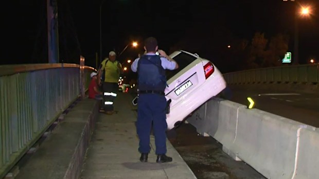 Police found a car mounted on a barrier in Homebush West. (9NEWS)