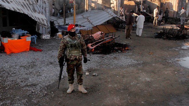 An Afghan security soldier stands guard after clashes between Taliban fighters and Afghan forces in Kandahar Airfield. (AP)