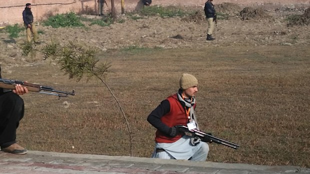 Pakistani security personnel taking position outside the Bacha Khan university following an attack by gunmen in Charsadda. (AFP)