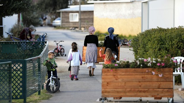 A picture taken on November 17, 2016 shows families in a street of the settlement outpost of Amona, which was established in 1997, in the Israeli-occupied West Bank. (AFP)