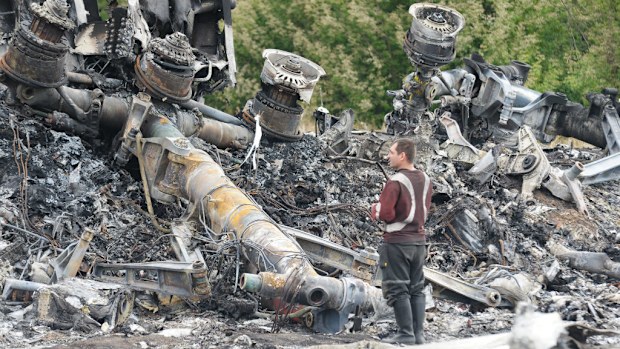 Experts inspect the wreckage of the Malaysia Airlines plane that crashed in Ukraine last week.