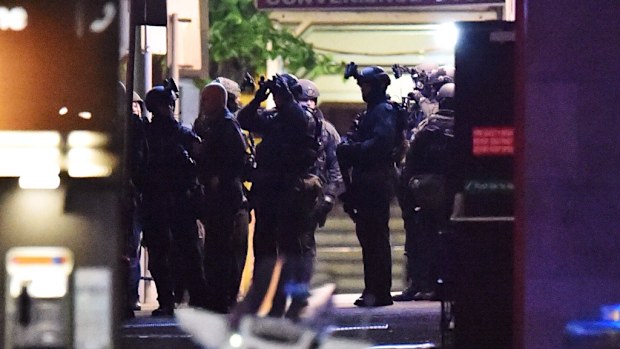 Police storm the Lindt chocolate cafe in Martin Place to end a siege December 16, 2014. (AAP)