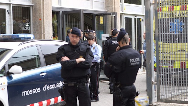 Spanish police outside high school Instituto Joan Fuster after a student allegedly killed a teacher. (AAP)