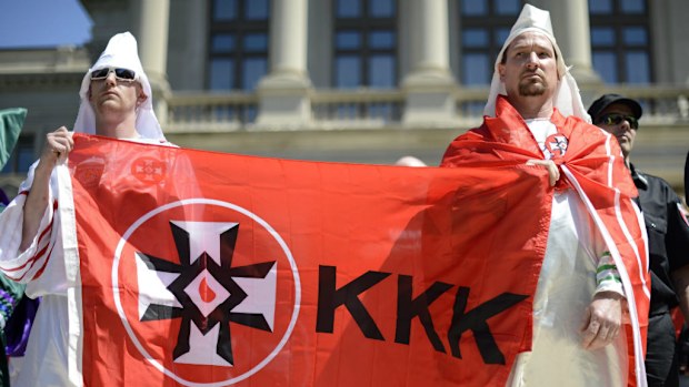 Ku Klux Klan demonstrators participate in an anti-illegal immigration rally sponsored by the National Socialist Movement in Atlanta, Georgia, USA, 20 April 2013. (EPA/ERIK S. LESSER)