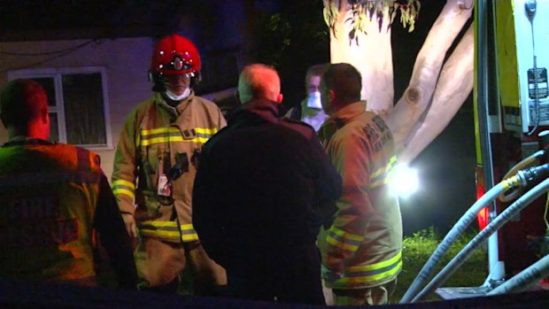 Firefighters were forced to abandon attempts to save a house on fire after they were allegedly threatened with an axe by a resident. (9NEWS)