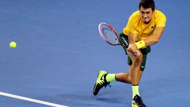 Bernard Tomic hits a backhand against Andy Murray. (AAP)