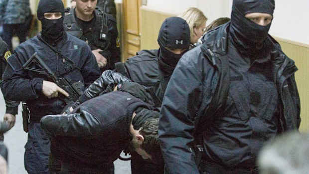 Taur Dadaev, a suspect in the murder of Russian politician Boris Nemtsov, is escorted by police. (AFP)