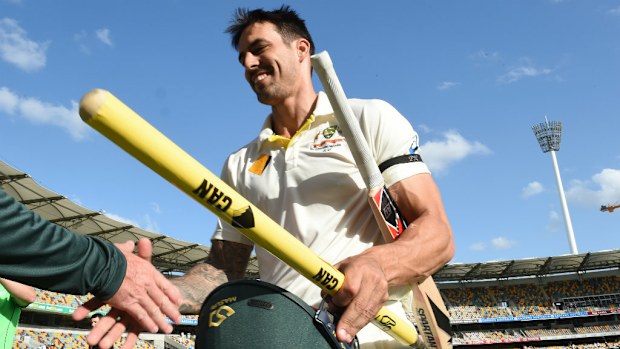 Mitchell Johnson leaves the pitch with a souvenir stump after Australia's win in the second Test. (AAP)