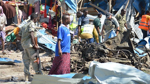 People inspect the scene of an attack with a bomb-laden vehicle at the market, known as Suqa Berta in Mogadishu, Somalia on November 26, 2016. (AFP)